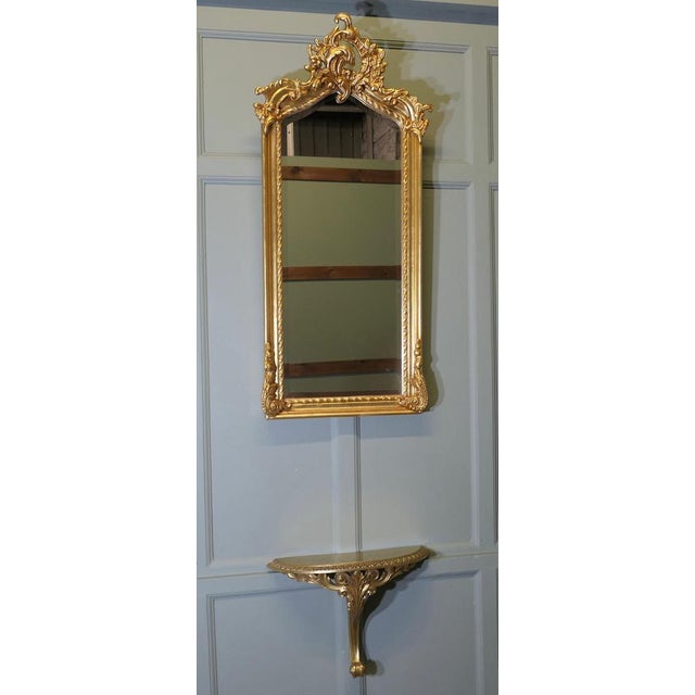 Tall Gilt Console Mirror with Shelf This is a very lovely piece, the mirror has an elaborate crest to the top of the very...