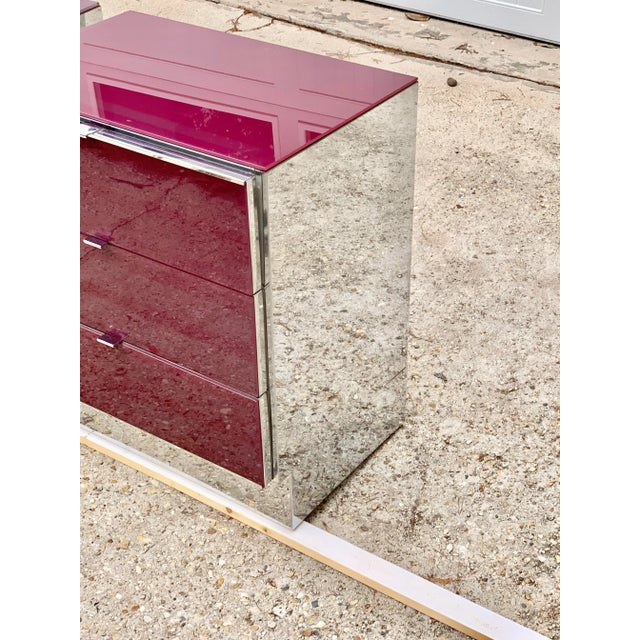 Fabulous pair of Ello glass and chrome nightstands. Each has a glass top and drawer fronts. It’s a deep red color- to me a...