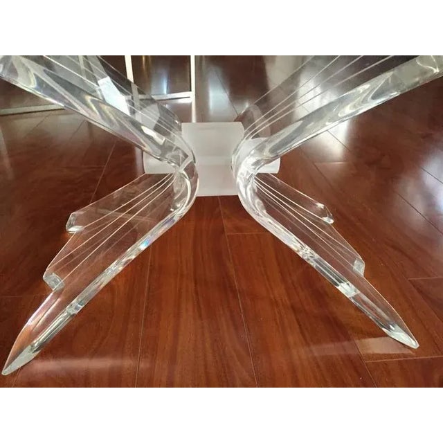 Mid-Century Modern coffee table with Lucite base and glass top. Beautiful Lucite base with very stylish legs. With beveled...
