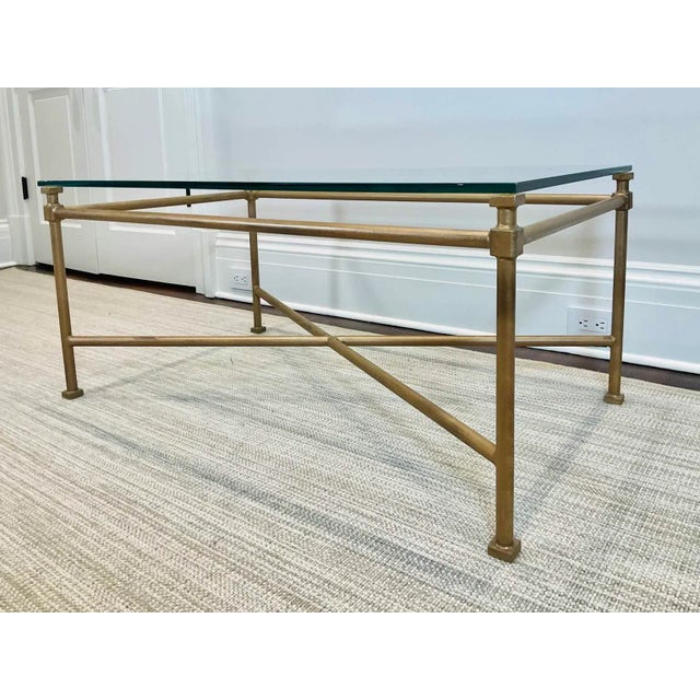 A vintage Niermann Weeks Italian style coffee table with an iron base in a bronze-colored finish, thick glass top,...