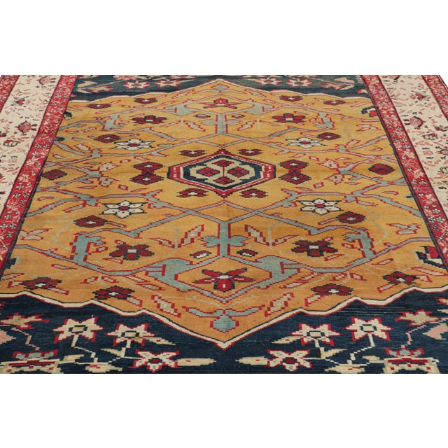 Hand-knotted in wool and originating from India circa 1920-1930, this 8×10 antique Agra rug is a rare and collectible jail...