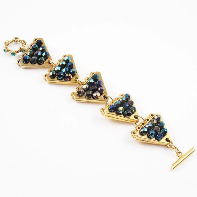 This stunning Claire Deve Paris link bracelet features a geometric shape with triangle gilt metal elements paved with...