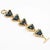 This stunning Claire Deve Paris link bracelet features a geometric shape with triangle gilt metal elements paved with...
