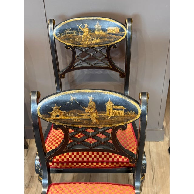A set of eight 20th century Regency style hand-painted Chinoiserie decorated side chairs, each with a black ground painted...