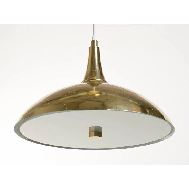 Brass and frosted glass lights with perforated brass shade. Beautiful effect when the light passes through metal shade....