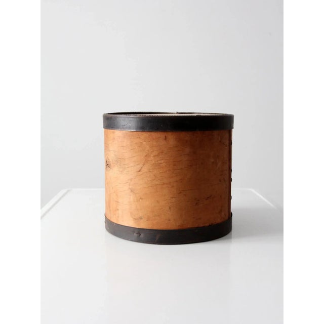 This is a vintage wooden cheese box dated 1953. The bentwood box features metal band framing at the base and lid. Black...