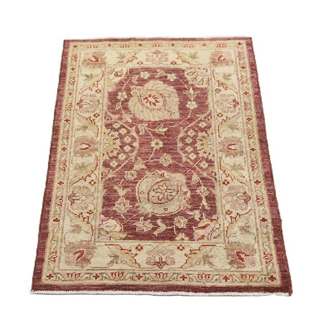 Hand-knotted with meticulous craftsmanship, this small area rug from the Ariana Traditional Collection showcases a classic...