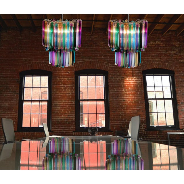 Fantastic pair of Murano chandeliers each made by 107 Murano crystal multicolored prism in a nickel metal frame. The...