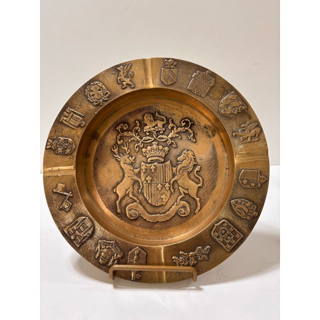 Unique vintage brass ashtray or wall hanging (has a hanger on the back) featuring a crest or coat of arms with a lion and...