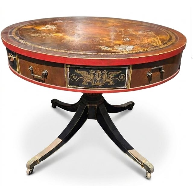 This piece of furniture is a striking English Regency-style drum table (also historicially referred to as a rent table),...