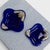 Vintage cobalt blue glass catchalls in a square silhouette, each adorned with a silver-plated floral rose motif overlay....
