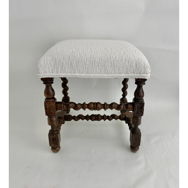 A gorgeous 19th century French Louis XIII revival period rectangular walnut stool, constructed with heavily detailed...