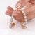 A mesmerizing tennis bracelet featuring a continuous row of oval moonstone cabochons set in warm gold-tone sterling...