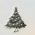 A lovely Christmas Brooch from the 1980s. It features a Christmas Tree in a silver metal with a black wash that resembles...