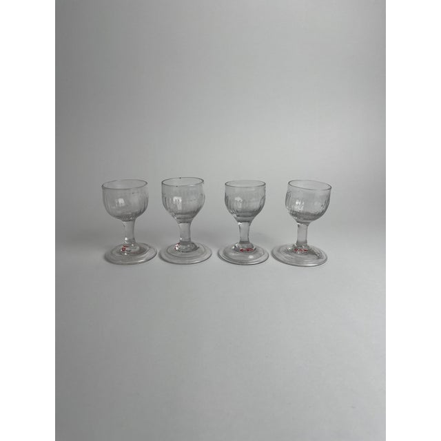 This set of four 18th-century cordial glasses exemplifies the elegance and refinement of Georgian-era glassware. Each...