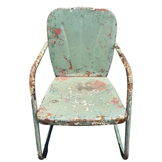 Steel Mid-century Springer Outdoor green enamel Lounge Chair. The chair features a round tubular U-shaped base that rocks...