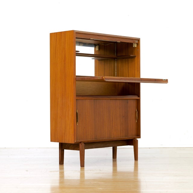 This vintage mid-century liquor Cabinet was produced in England by Beaver & Tapley during 1970s. Made from afromosia and...