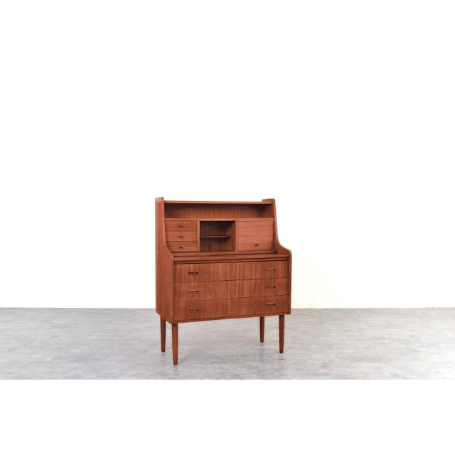A teak secretary from the 1960s, designed in the spirit of Scandinavian modernism and manugactured in Denmark. Its most...