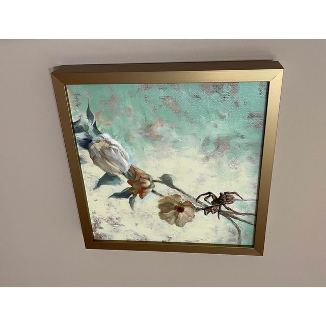This artwork presents a delicate interplay between nature and the unexpected, featuring a spider poised among softly...