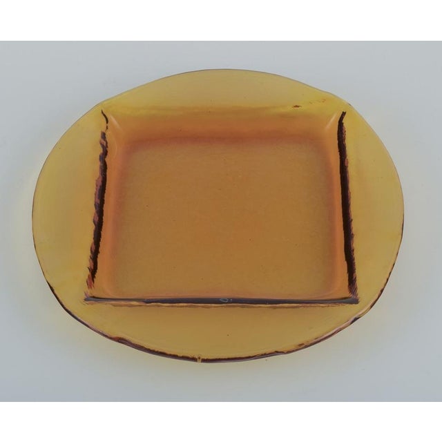 Scandinavian glass designer. A set of six dinner plates in smoke-coloured art glass. Square indentation in the plate....