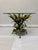 This striking coffee table features a highly sculptural enameled metal base designed as a lush, three-dimensional floral...