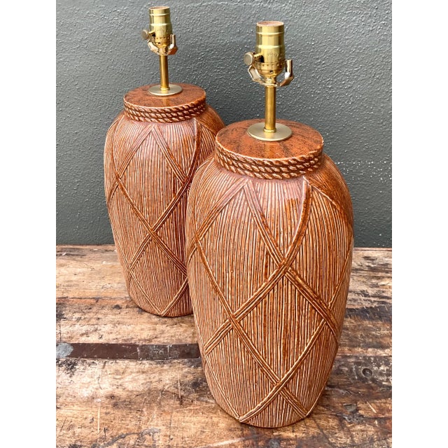 This pair of vintage ceramic table lamps embodies the confident, tactile spirit of Mid-Century Modern design, dating to...