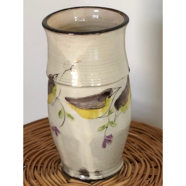 A vintage studio pottery vase, signed by the artist and decorated with beautiful French birds on a wire painted on creamy...