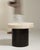 An early 20th century side table combining a wrought iron base with a stone top, reflecting the design vocabulary shared...