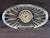 Elegant clear crystal with sunburst facet cuts. Oval shape. Classic round clock insert with Roman numerals. Shimmering...