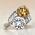 A striking platinum two-stone diamond ring featuring an exceptional pairing of colorless and fancy-colored diamonds. The...