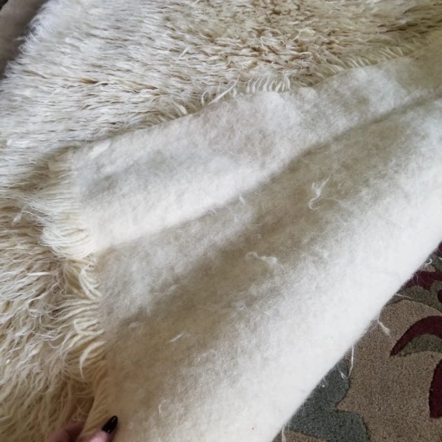 This wonderfully weighty wool blanket will keep you warm all winter long. Pictured above on the foot of a king size bed....