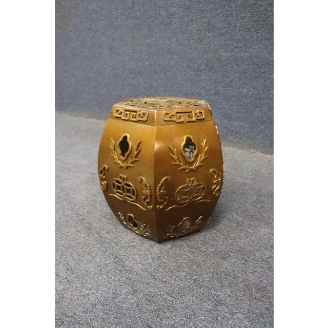 Hexagonal brass garden stool featuring a warm gold-toned finish with raised Chinese-inspired motifs, geometric Greek key...