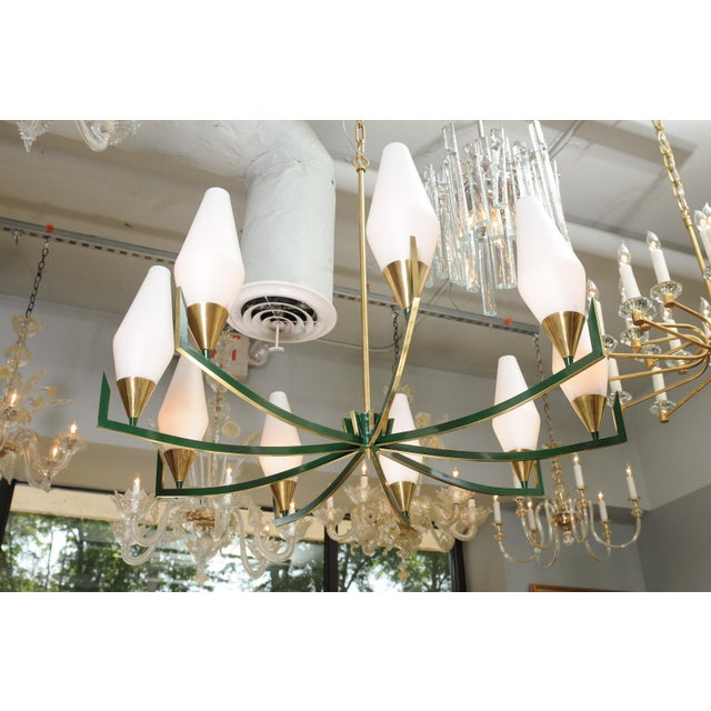 This is an elegantly restored 10-light chandelier in the manner of Stilnovo, a mid-century German lighting manufacturer,...