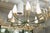 This is an elegantly restored 10-light chandelier in the manner of Stilnovo, a mid-century German lighting manufacturer,...