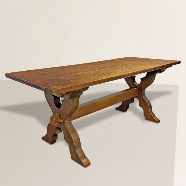 An early 20th-century Danish trestle table, circa 1900–1920s, crafted from thick solid oak planks and built with a clarity...