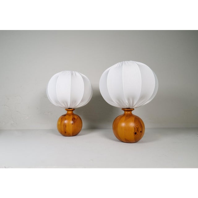 Wonderful, sculptured table lamps made with rounded solid grained pine. The globe grained pine working well with the all-...