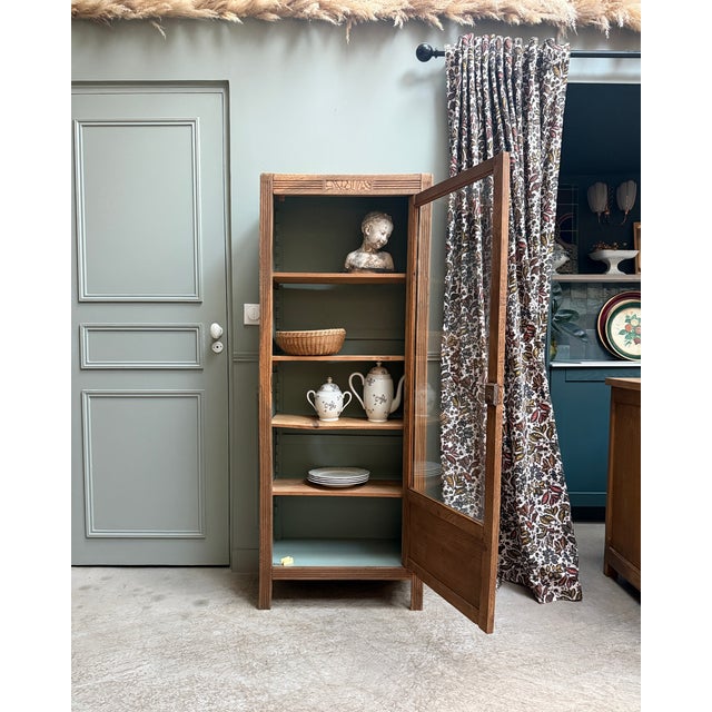 An elegant small parisian oak display cabinet dating from the 1930s. Its slender shape and typically art deco geometric...