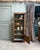 An elegant small parisian oak display cabinet dating from the 1930s. Its slender shape and typically art deco geometric...