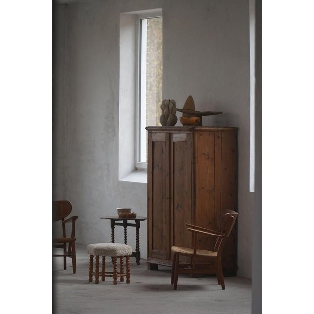 A charming primitive antique cabinet in pine, made with wooden fittings. Handcrafted by a swedish cabinetmaker in the late...