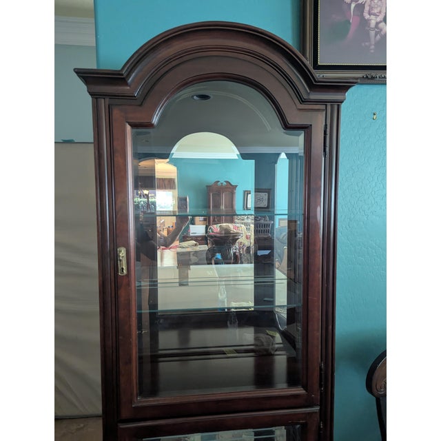 USA made Jasper Cabinet Company cherry curio cabinet. Mirrored back with adjustable glass shelves, lockable doors and...