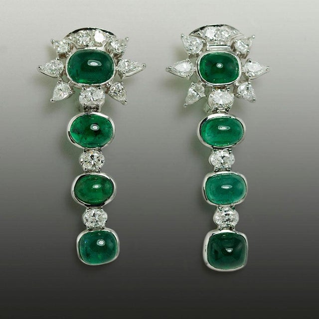 18k White gold earrings with 8 cabochon emeralds weighing 18,75 carats and 22 round, pear shape and oval diaamonds...