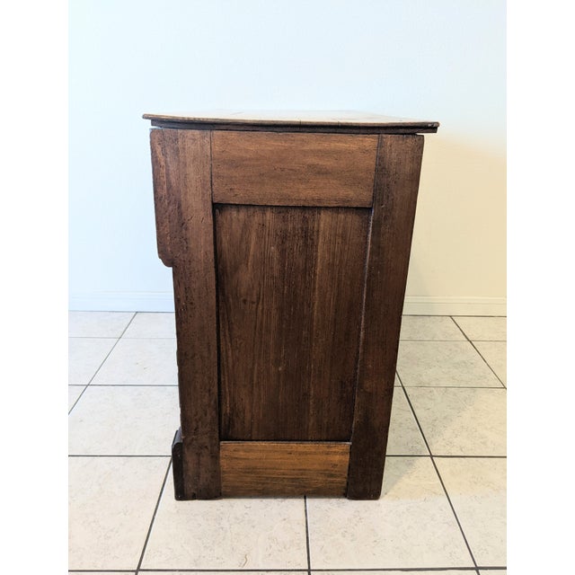 A late 1800s Eastlake chest of drawers or entry console features beautiful carvings, 3 spacious drawers, and Pin & Cove...