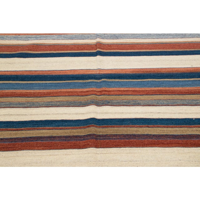 Beautiful Modern Kilim hand-knotted wool rug with multicolor accents in an all-over geometric design. This rug measures...