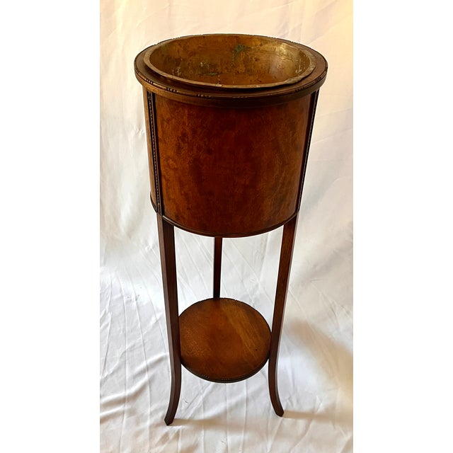 Antique Edwardian style mahogany plant stand with burl wood wrapped container. Removable copper insert. Carved detail...