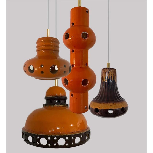 A set of spectacular and stylish ceramic pendant lights made in west-germany around 1970's. The lights are made of orange...