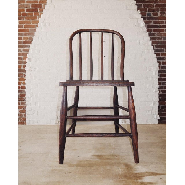 Pair of Windsor Farmhouse Chairs in solid wood with a warm, timeworn patina. Each chair features a classic hoop back with...