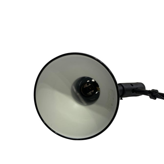 This vintage black task lamp embodies the clean functionality and sculptural restraint of mid-century modern industrial...