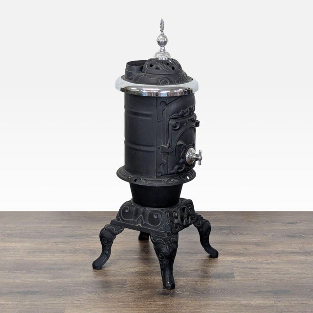This antique cast iron parlor stove is a stunning addition to any home. It features ornate detailing with elegant silver...