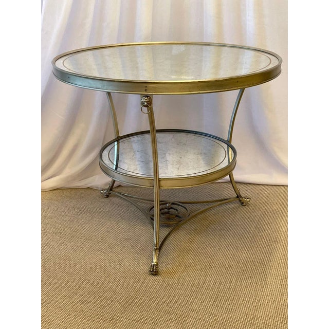 Hollywood Regency Style Mirrored Gueridon, Center Table. A sleek and stylish Silver gilt gueridon having Lion head ringed...