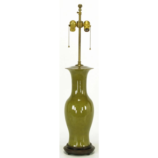 Warren Kessler ceramic vase-bodied table lamp. Excellent crackle glaze on olive green. Carved wood base with brass cap and...